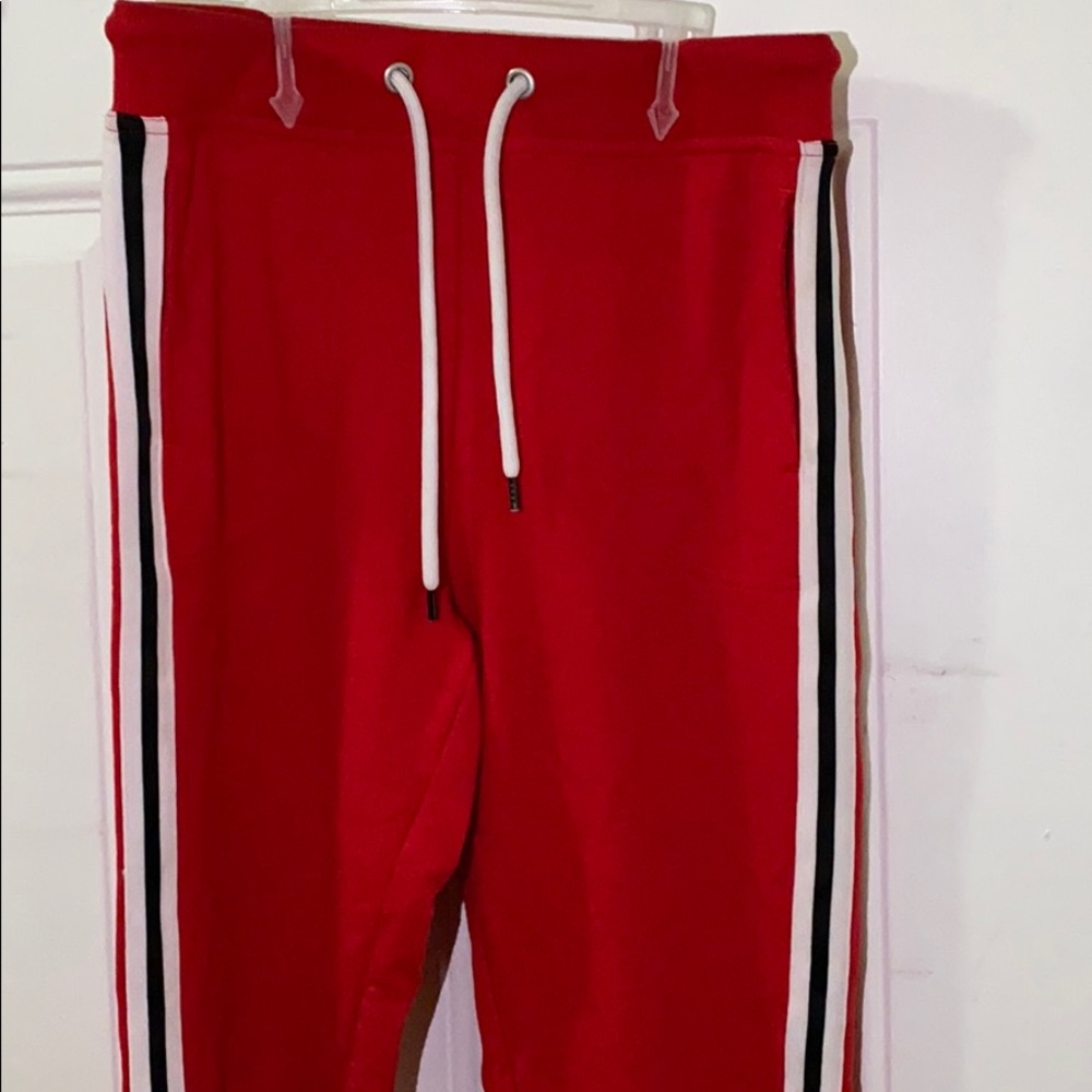 Red jogger, black and white stripes on the side.